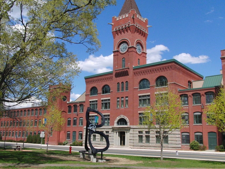 A large brick building with a clock tower built into it.