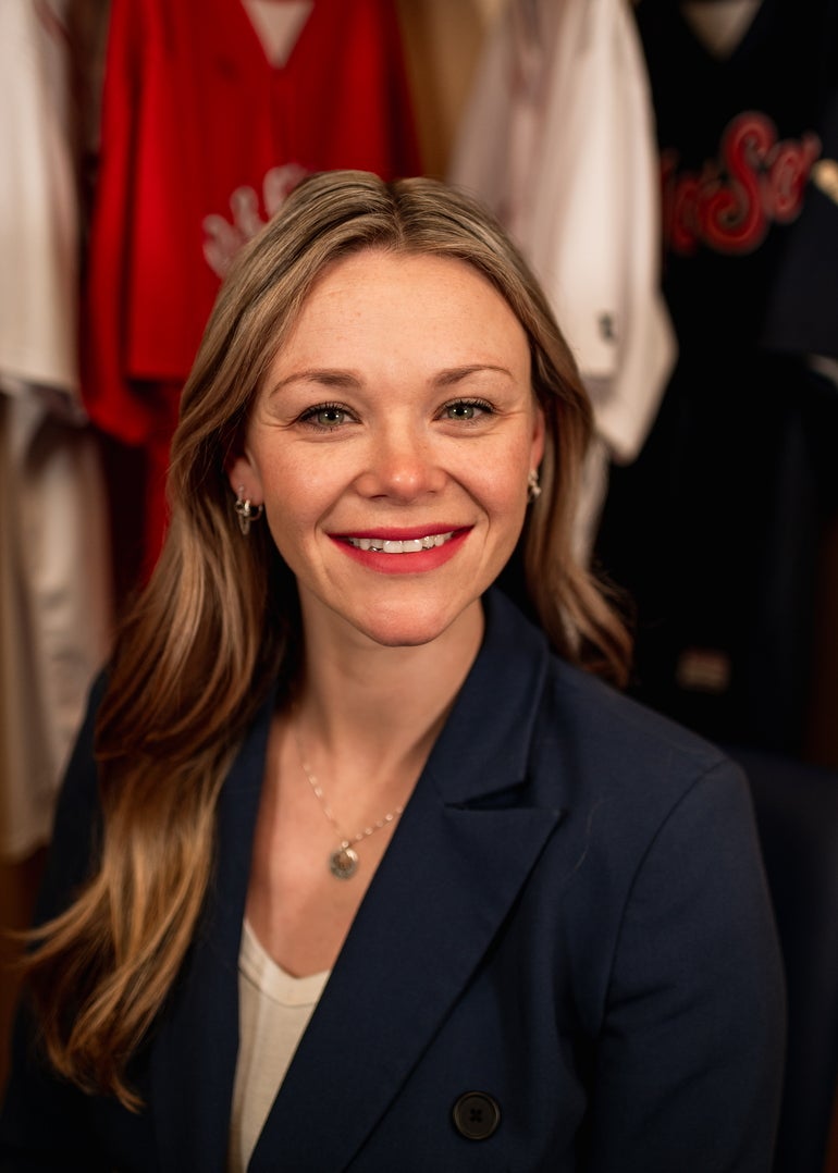 A profile photo of a woman in a suit jacket