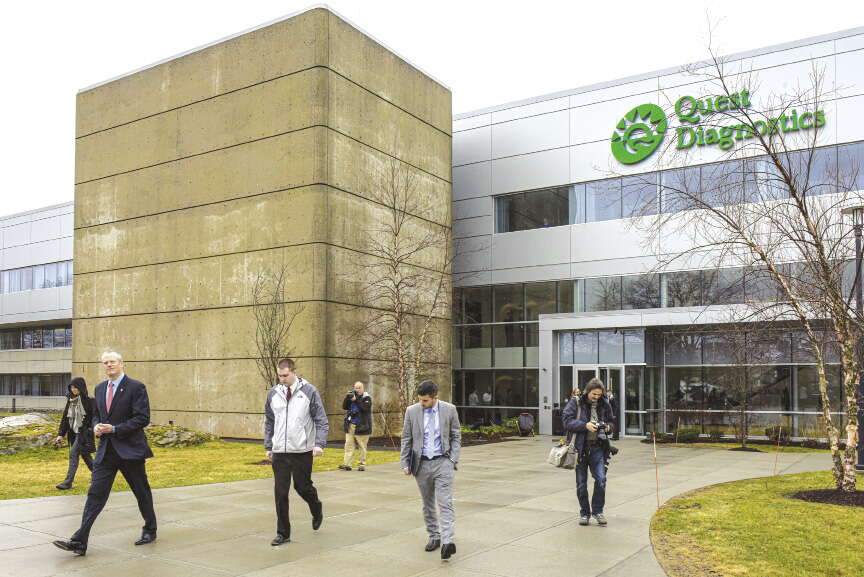 People leave a suburban office building 
