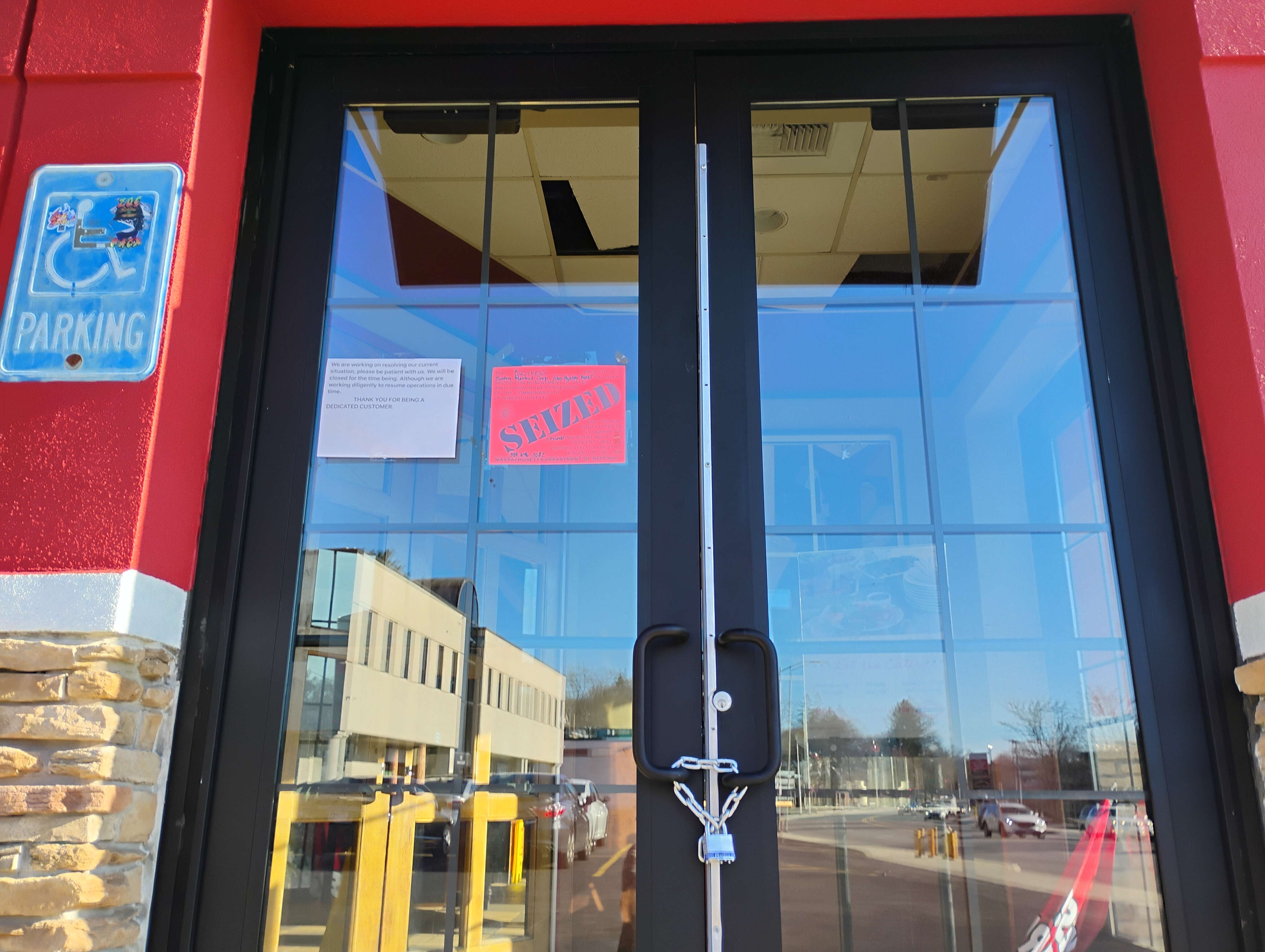 A padlocked door with signage