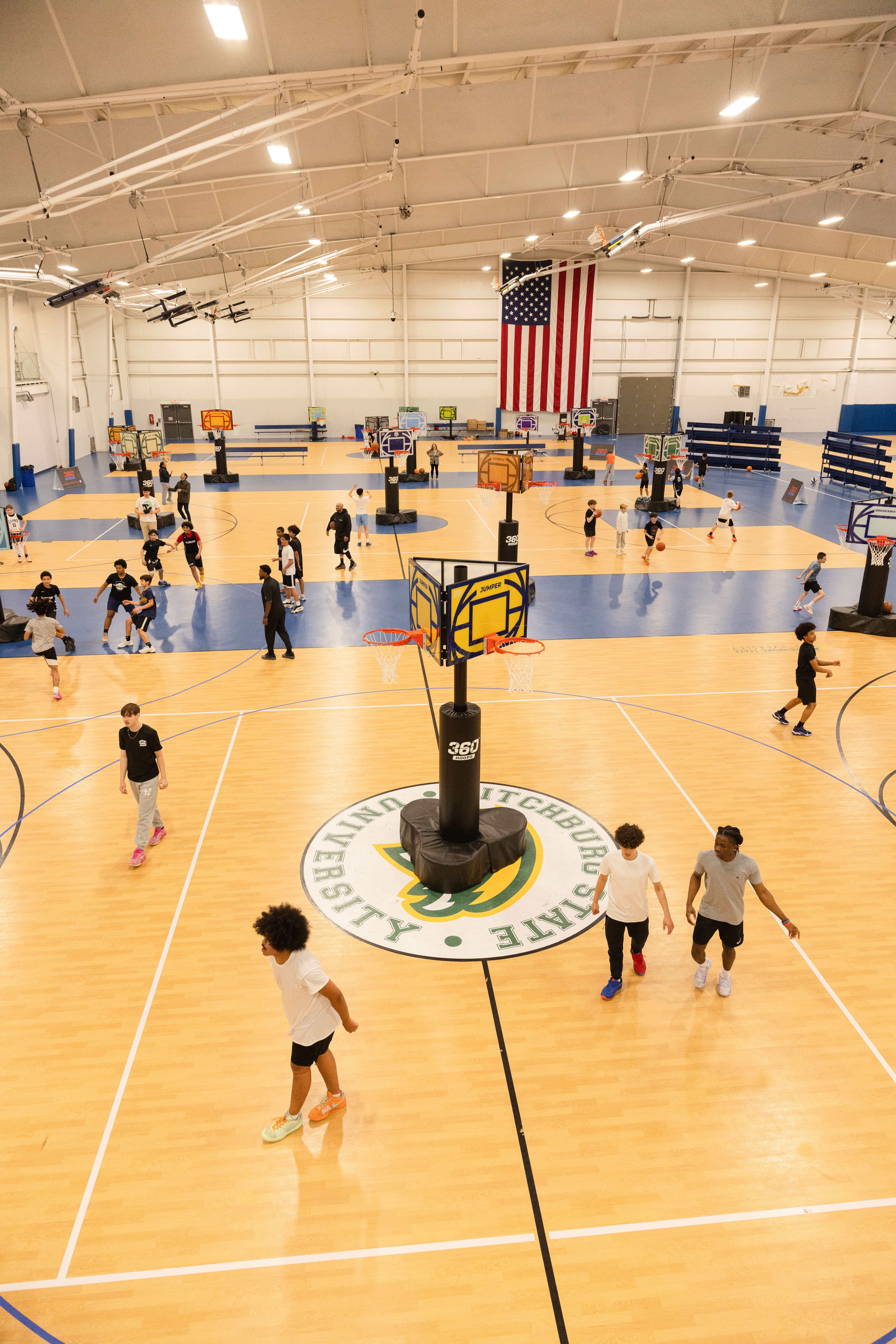A large gymnasium space featuring multiple games of 360 Hoops going on