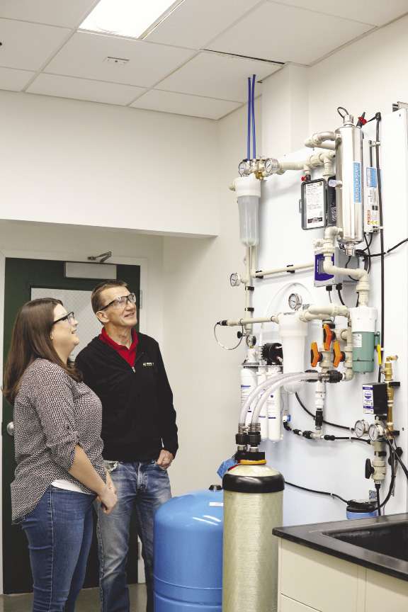A man and a woman examine equipment