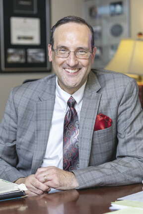 A man in a suit with a red pocket square