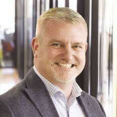 a portrait photo of a man in a suit