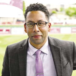 A man with glasses in a suit