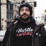 A man standing on a street corner looking at the camera