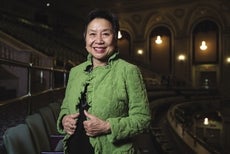 Anh Vu Sawyer poses for a portrait photograph in a theater