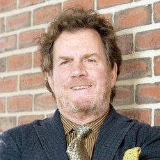a man smiling in a suit