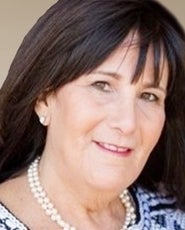 A headshot photo of a woman wearing a necklace