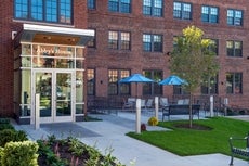 A photo of Abby's House at 52 High Street in Worcester, a brick building with an outdoor patio