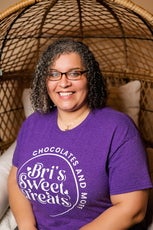 A young woman with black hair wearing a purple shirt