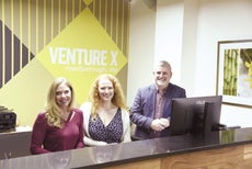 Three people standing behind a counter