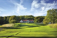 A building sits behind a golf course