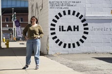 A woman stands outside a building