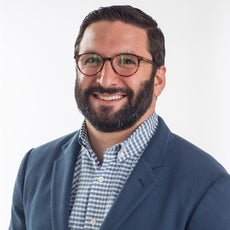 a portrait photo of a man in a suit