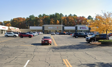 A plaza with a big box retail location behind its parking lot
