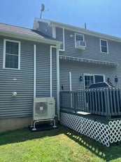 Heat pump set up outside home with duct work