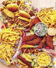 A selection of Nashville hot chicken sandwiches, tenders, fries, Mac and cheese, and other food items