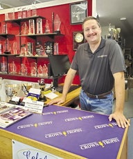 A man stands in front of a counter.