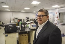 Gary Kaufman, co-founder of the ABI-LAB, stands dressed in a suit in one of the incubator's lab spaces.  at .