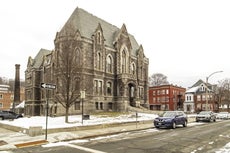 A three-or-so-story, gothic-looking stone courthouse building
