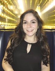 Woman in black dress smiles