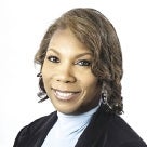 A headshot photo of a woman wearing a turtleneck