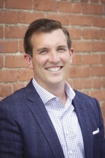 A smiling headshot of James Cunningham