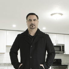 A man stands in an empty apartment