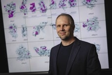 A picture of Dmitry Korkin in front of scans.