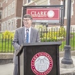 A photo of Jack Foley behind a podium at Clark University