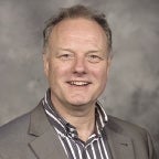 A smiling headshot of a man