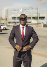 A man in a suit and sunglasses