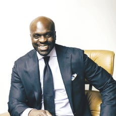 A smiling man in a suit