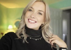 A blond woman in a black turtleneck