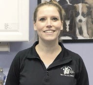 A woman in a black polo shirt