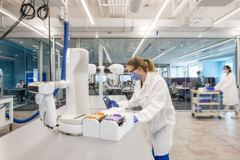 A person operates scientific equipment in a lab