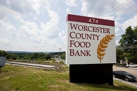 A roadside sign for the Worcester County Food Bank displays its logo.