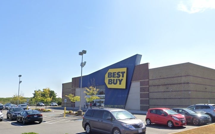 Photo of Best Buy electronics store in parking lot with cars