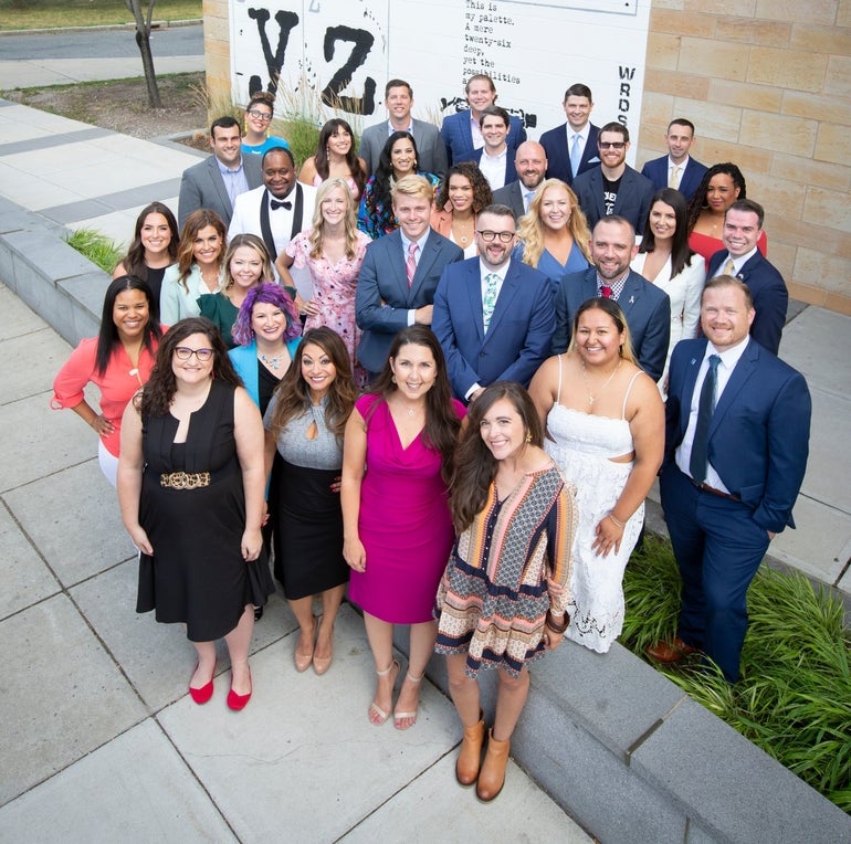 A group of young people standing in front of the Worcester Public Library