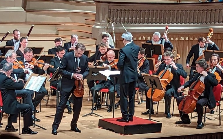 A group of musicians play in an orchestra
