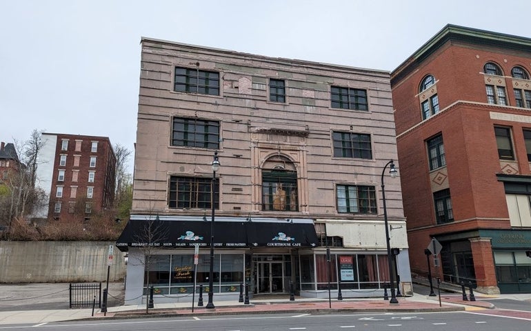A four-story building with a cafe on the first floor