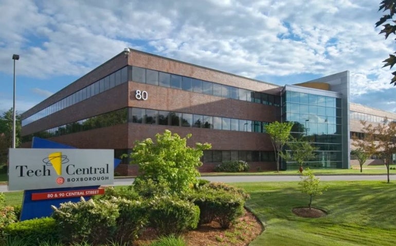 A three-story office building with a colorful sign that reads Tech Central Boxborough