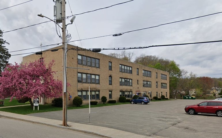 A three-story beige school building