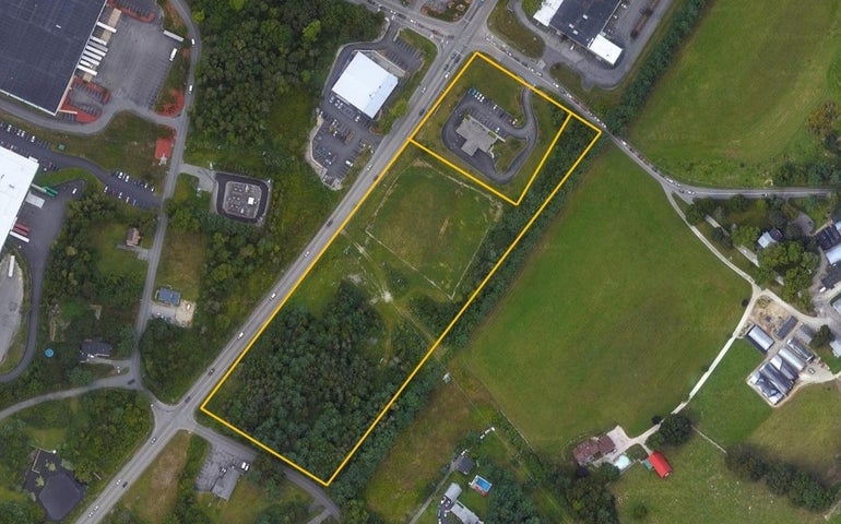 A satellite view of a large property bounded by yellow lines