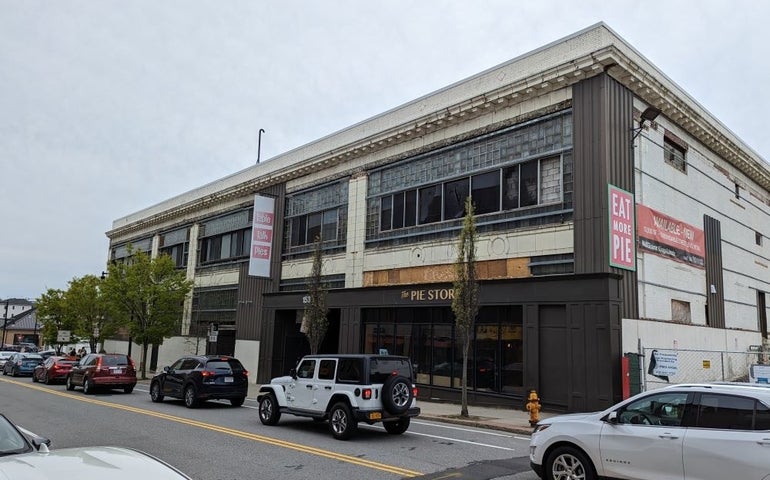 A two-story building with The Pie Store written on the front