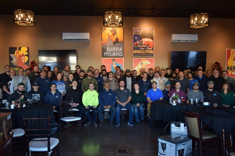 A large group of people pose for a photograph. 