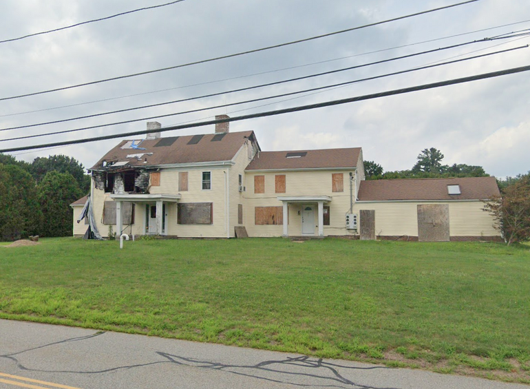 A two-story building with fire damage