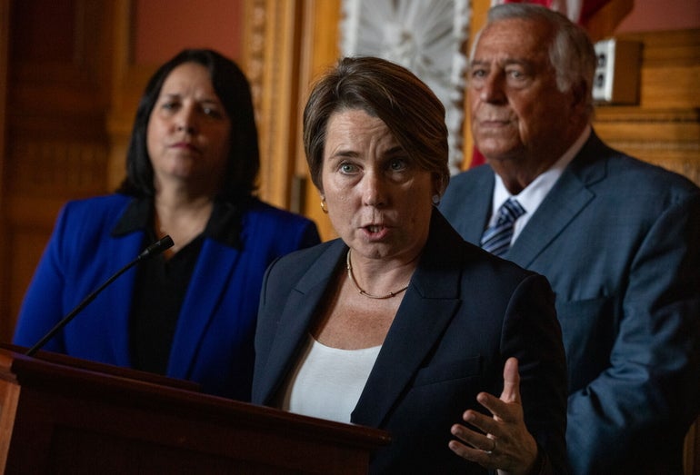 A woman stands in front of a podium