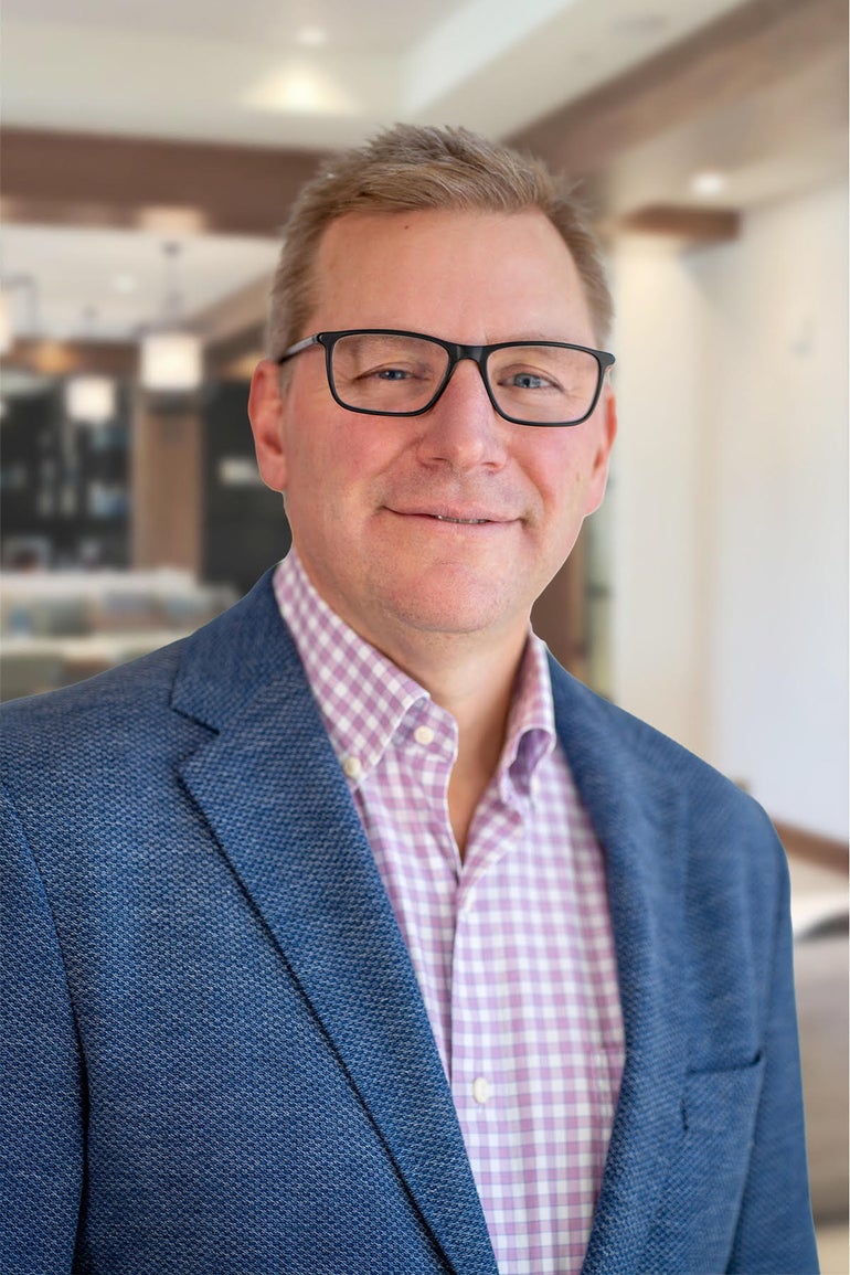 A man with glasses in a suit